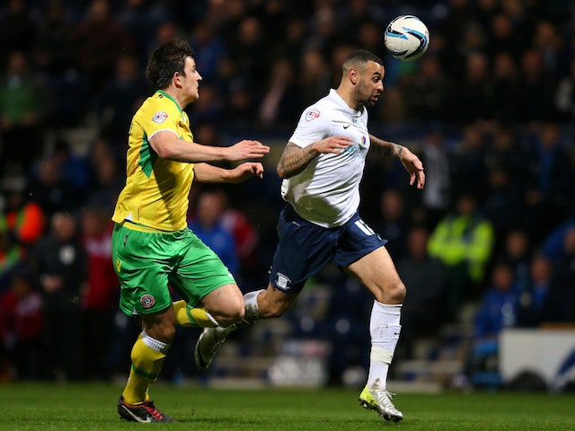 Craig Davies of Preston North End beats Harry Maguire of Sheffield United during the Sky Bet League One match on March 17, 2014