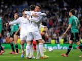 Cristiano Ronaldo of Real Madrid celebrates with teammate Gareth Bale after scoring the opening goal during the UEFA Champions League Round of 16 second leg match against Schalke on March 18, 2014