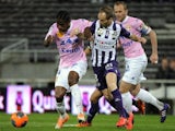 Toulouse's French midfielder Etienne Didot (C) vies for the ball with Evian's Ivoirian midfielder Eric Tie Bi during the French L1 football match on March 22, 2014