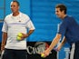 Andy Murray of Great Britain serves as his coach Ivan Lendl looks on during training on day 10 of the 2013 Australian Open on January 23, 2013