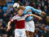 Joleon Lescott of Manchester City and Alexander Kacaniklic of Fulham compete for the header during the Barclays Premier League match on March 22, 2014