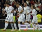 Real's Karim Benzema celebrates with teammates after scoring his team's first goal against Barcelona in the La Liga match on March 23, 2014
