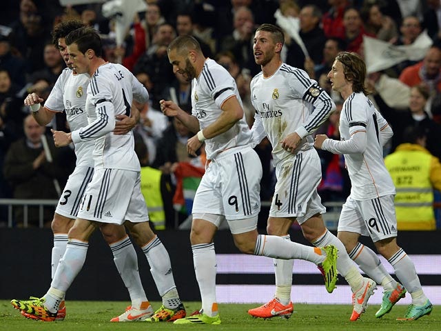 Real's Karim Benzema celebrates with teammates after scoring his team's first goal against Barcelona in the La Liga match on March 23, 2014