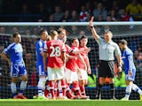 Referee Andre Marriner shows Kieran Gibbs of Arsenal a red card during the Barclays Premier League match between Chelsea and Arsenal at Stamford Bridge on March 22, 2014 