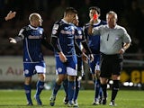 Matthew Lund of Rochdale is shown a red card by referee Mark Heywood after receiving a second yellow card for his celebration after scoring against Northampton on March 18, 2014
