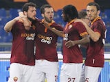 Mattia Destro (L) with his teammates of AS Roma celebrates after scoring the second team's goal during the Serie A match against Udinese on March 17, 2014