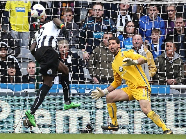 Newcastle United's Senegalese striker Papis Cisse scores a final minute winner during the English Premier League football match against Crystal Palace on March 22, 2014