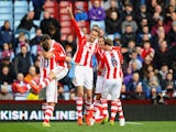 Peter Crouch (C) of Stoke celebrates with teammates after scoring his team's second goal during the Barclays Premier League match against Aston Villa on March 23, 2014