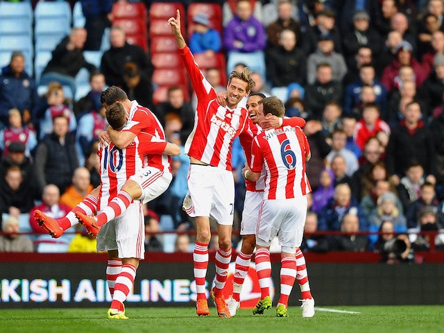 Peter Crouch (C) of Stoke celebrates with teammates after scoring his team's second goal during the Barclays Premier League match against Aston Villa on March 23, 2014