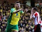 Robert Snodgrass of Norwich City celebrates scoring the opening goal as a dejected John O'Shea of Sunderland reacts during the Barclays Premier League match on March 22, 2014
