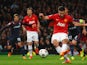Robin van Persie of Manchester United scores the opening goal from a penalty kick during the UEFA Champions League Round of 16 second round match against Olympiacos on March 19, 2014