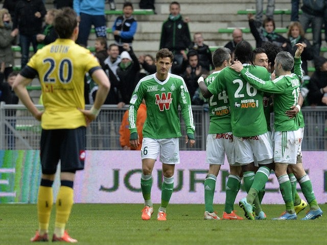 Saint-Etienne's players (R) celebrate after scoring a goal during the French L1 football match AS Saint-Etienne (ASSE) vs FC Sochaux (FCSM) on March 23, 2014