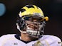 Taylor Lewan #77 of the Michigan Wolverines in action during the Buffalo Wild Wings Bowl against the Kansas State Wildcats at Sun Devil Stadium on December 28, 2013
