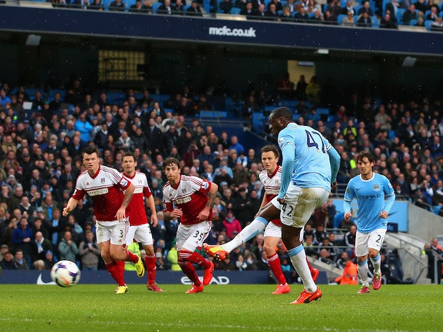 Yaya Toure of Manchester City scores the opening goal from the penalty spot during the Barclays Premier League match against Fulham on March 22, 2014
