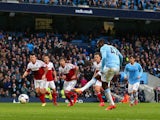 Yaya Toure of Manchester City scores the opening goal from the penalty spot during the Barclays Premier League match against Fulham on March 22, 2014