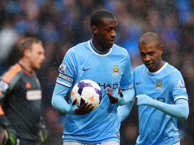 Yaya Toure of Manchester City celebrates scoring their second goal with Fernandinho of Manchester City during the Barclays Premier League match against Fulham on March 22, 2014