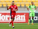 Marcelo Carrusca of Adelaide United celebrates after scoring a goal while Glen Moss of the Phoenix looks on during the round 25 A-League match between Wellington Phoenix and Adelaide United at Westpac Stadium on March 30, 2014