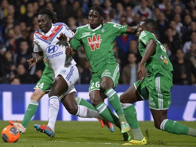 Lyon's Bafétimbi Gomis vies with St Etienne's pair Moustapha Bayal Sall and Josuha Guilavogui during the Ligue 1 match on March 30, 2014