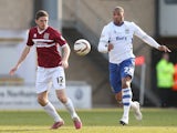 Ben Tozer of Northampton Town looks for the ball with Clive Platt of Bury during the Sky Bet League Two match on March 29, 2014