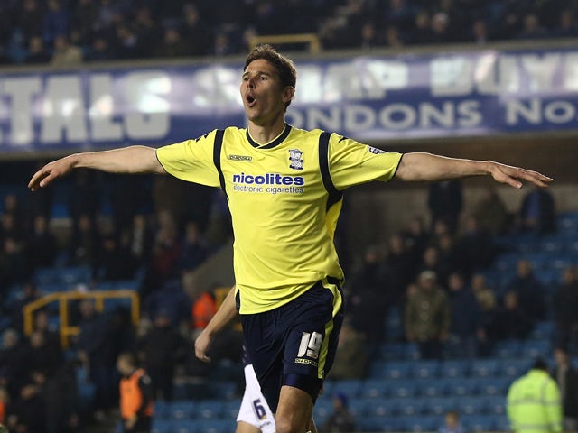 Nicola Zigic of Birmingham celebrates after scoring their third goal of the game during the Sky Bet Championship match between Millwall and Birmingham City at The Den on March 25, 2014
