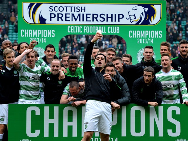 The Celtic squad celebrate winning the 2013-2014 Championship after the Scottish Premier League match between Celtic and Ross County at Celtic Park Stadium on March 29, 2014