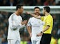Referee Alberto Undiano Mallenco talks to Pepe (L), Cristiano Ronaldo and Xabi Alonso of Real Madrid during the La Liga match between their side and Barcelona on March 23, 2014