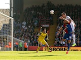 John Terry of Chelsea is pressured by Joe Ledley of Crystal Palace and heads the ball over his goalkeeper Petr Cech to open the scoring with an own goal during the Barclays Premier League match between Crystal Palace and Chelsea at Selhurst Park on March 