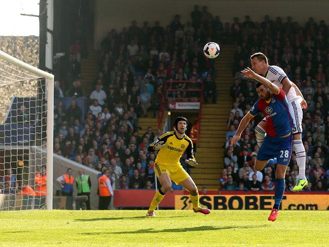 John Terry of Chelsea is pressured by Joe Ledley of Crystal Palace and heads the ball over his goalkeeper Petr Cech to open the scoring with an own goal during the Barclays Premier League match between Crystal Palace and Chelsea at Selhurst Park on March 