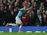 Manchester City's Bosnian forward Edin Dzeko celebrates after scoring the opening goal during the English Premier League football match between Manchester United and Manchester City at Old Trafford in Manchester on March 25, 2014