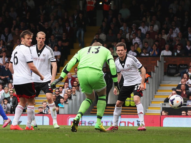 Goalkeeper David Stockdale of Fulham fails to stop a shot by Steven Naismith of Everton for the opening goal during the Barclays Premier League match between Fulham and Everton at Craven Cottage on March 30, 2014