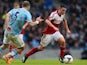 Patrick Roberts of Fulham is tracked by Pablo Zabaleta of Manchester City during the Barclays Premier League match between Manchester City and Fulham at Etihad Stadium on March 22, 2014
