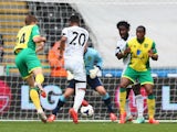 Jonathan de Guzman of Swansea City scores the opening goal during the Barclays Premier League match against Norwich City on March 29, 2014