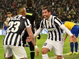Juventus' Argentinian foward Carlos Tevez celebrates after scoring a second goal with teammate Juventus' Chilean midfielder Arturo Vidal during the Italian Serie A football match Juventus vs Parma at 'Juventus Stadium' in Turin on March 26, 2014