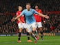 Edin Dzeko of Manchester City celebrates scoring the second goal during the Barclays Premier League match between Manchester United and Manchester City at Old Trafford on March 25, 2014