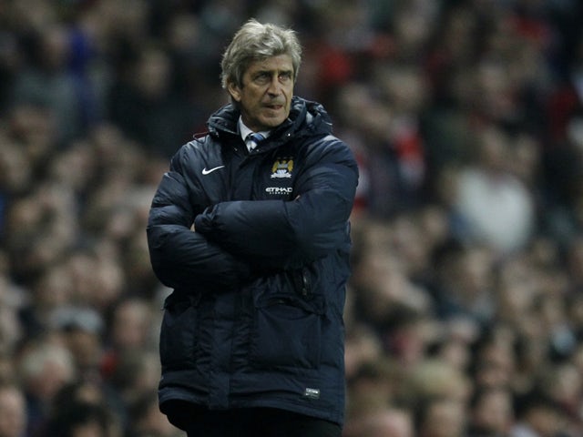 Manchester City's Chilean manager Manuel Pellegrini watches from the touchline during the English Premier League football match between Arsenal and Manchester City at the Emirates Stadium in London on March 29, 2014