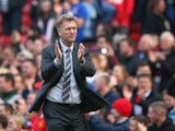 Manchester United Manager David Moyes applauds the fans at the end of the Barclays Premier League match between Manchester United and Aston Villa at Old Trafford on March 29, 2014