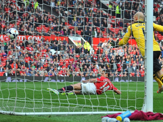 Manchester United's Mexican striker Javier Hernandez scores his team's fourth goal during the English Premier League football match between Manchester United and Aston Villa at Old Trafford in Manchester, northwest England, on March 29, 2014