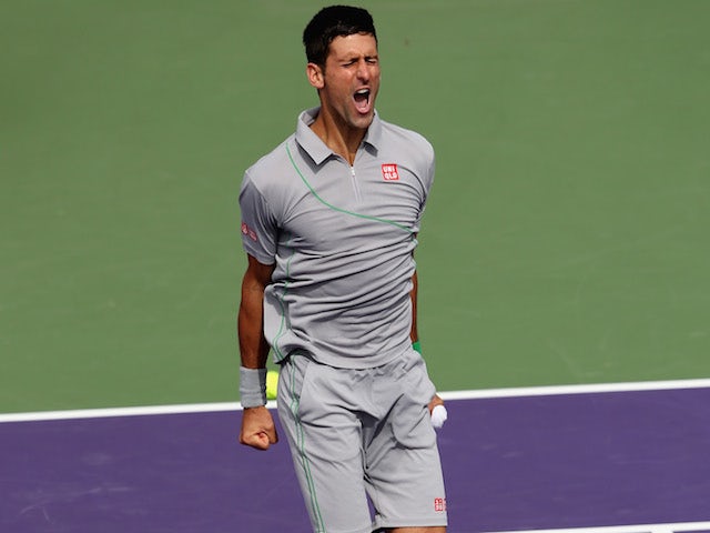 Novak Djokovic of Serbia jumps into the air to celebrate to the crowd after his straight sets victory against Rafael Nadal of Spain during their final match on March 30, 2014