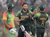 Pakistan cricketer Shahid Afridi celebrates with captain Mohammad Hafeez after the dismissal of Bangladesh cricketer Shamsur Rahman during the ICC World Twenty20 tournament Group 2 cricket match between Bangladesh and Pakistan at The Sher-e-Bangla Nationa