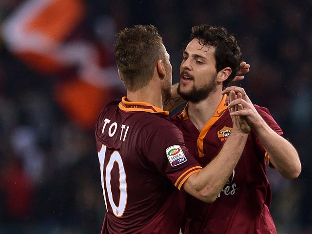 AS Roma's forward Mattia Destro is congratulated by his teammate AS Roma's forward Francesco Totti, after he scored a goal during the Italian Serie A football match between As Roma and Torino on March 25, 2014
