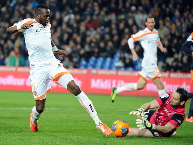 Valenciennes' French midfielder Tongo Hamed Doumbia vies for the ball with Montpellier's French goalkeeper Geoffrey Jourdren during the French L1 football match Montpellier vs Valenciennes on March 29, 2014