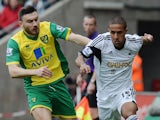 Wayne Routledge of Swansea City is closed down by Robert Snodgrass of Norwich City during the Barclays Premier League match on March 29, 2014