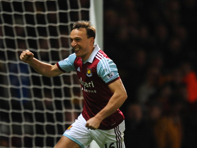 Mark Noble of West Ham celebrates scoring the opening goal from the penalty spot during the Barclays Premier League match between West Ham United and Hull City at Boleyn Ground on March 26, 2014