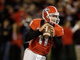 Quarterback Aaron Murray #11 of the Georgia Bulldogs rolls out and looks downfield during the game against the Kentucky Wildcats at Sanford Stadium on November 23, 2013