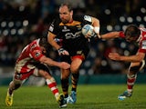 Andy Goode of London Wasps is tackled by Henry Trinder (L) and Billy Twelvetrees (R) of Gloucester during the Amlin Challenge Cup Quarter Final match on April 6, 2014
