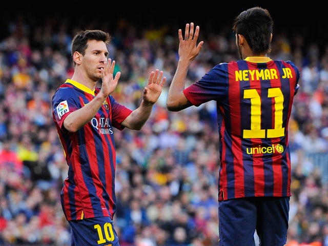 Neymar of FC Barcelona celebrates with his team-mate Lionel Messi of FC Barcelona during the La Liga match between FC Barcelona and Real Betis Balompie at Camp Nou on April 5, 2014