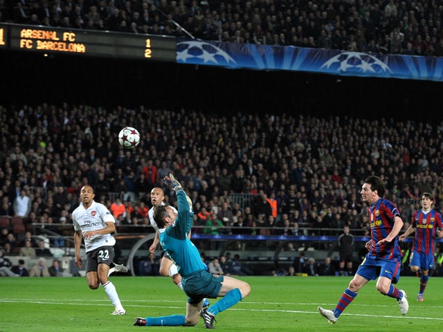 Barcelona's Argentinian forward Lionel Messi chips the ball over Arsenal's Spanish goalkeeper Manuel Almunia to score his hat-trick during the Champions League quarter-final second-leg match at Camp Nou stadium in Barcelona on April 6, 2010
