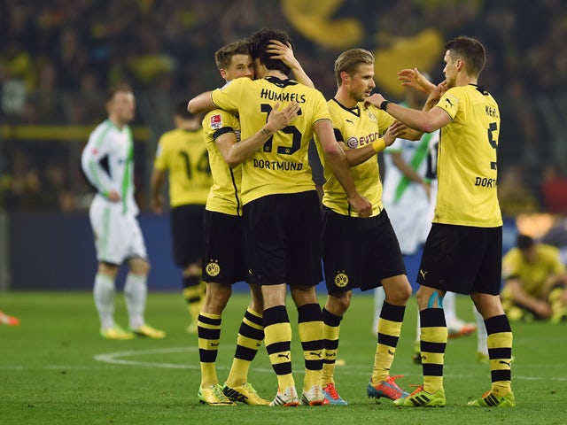 Dortmund´s players celebrate after the German first division Bundesliga football match Borussia Dortmund vs VfL Wolfsburg in Dortmund, western Germany, on April 5, 2014
