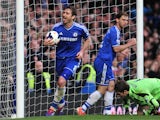 :Chelsea's English midfielder Frank Lampard celebrates scoring Chelsea's second goal from the rebound after Stoke City's Bosnian goalkeeper Asmir Begovic saved Lampard's penalty kick during the English Premier League football match between Chelsea and Sto