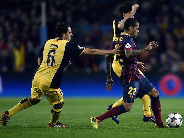 Barcelona's Brazilian defender Dani Alves (R) vies with Atletico Madrid's midfielder Koke (L) during the UEFA Champions League quarterfinal first leg football match on April 1, 2014